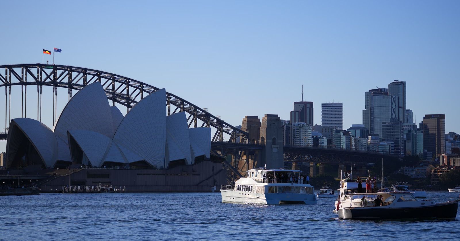 Sydney Opera House and the Harbour Bridge, with ferries on the harbour
