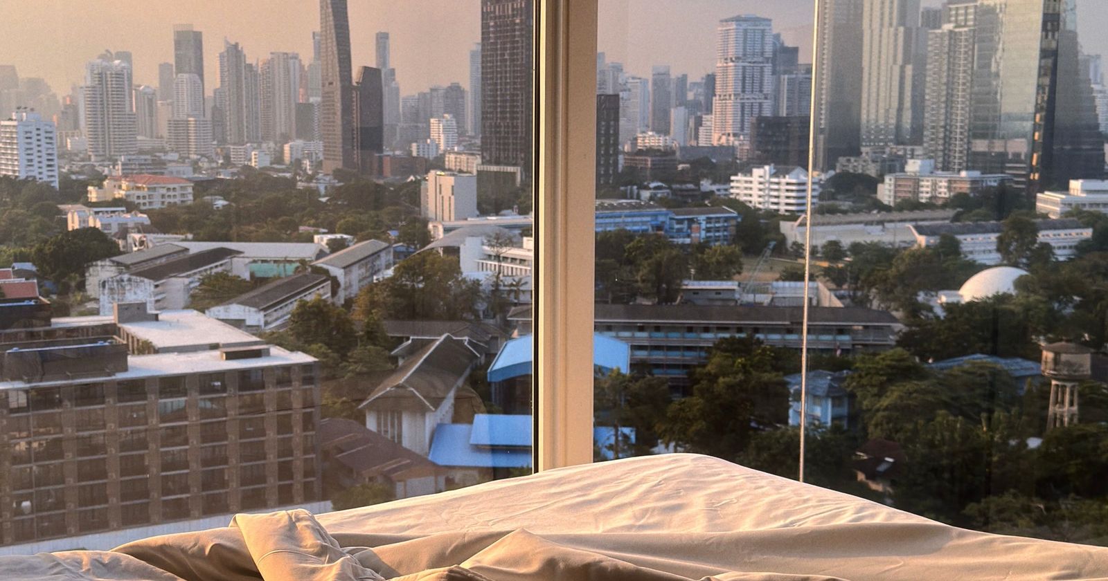 View from a high apartment window over a city of tall buildings