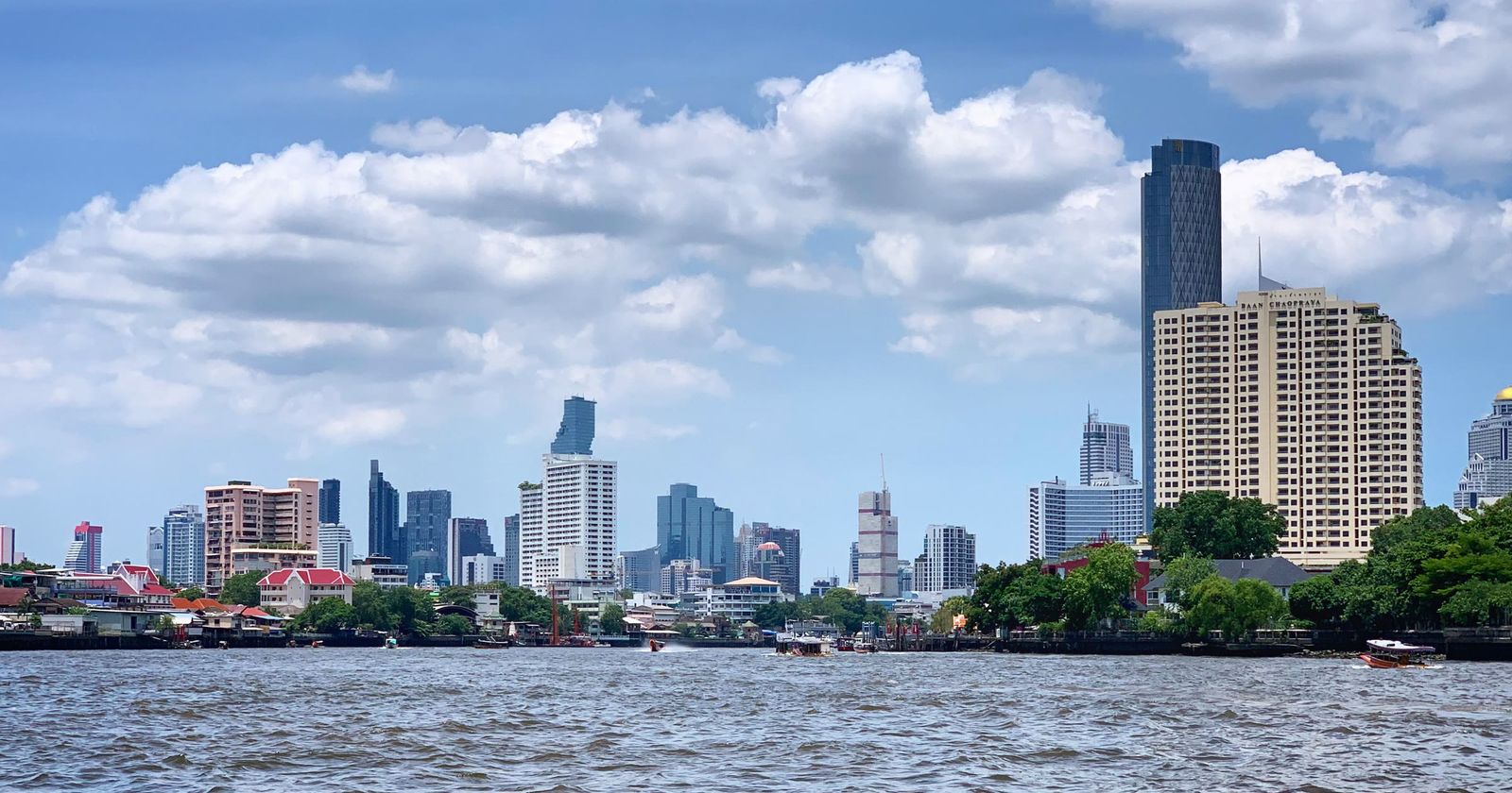 Bangkok's skyline across the Chao Phraya river on a sunny day