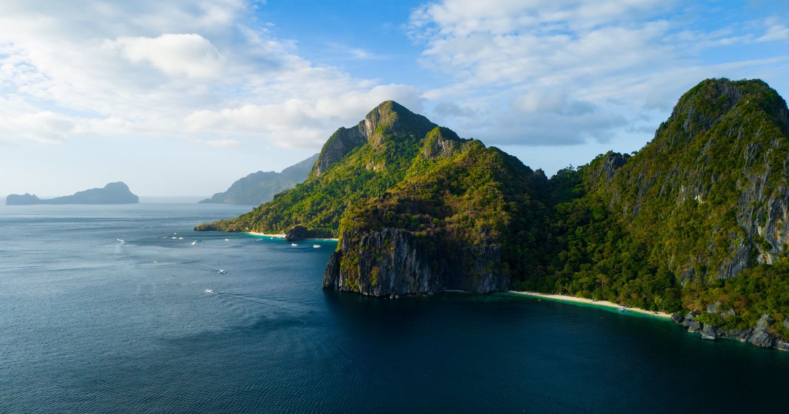 Limestone islands rising out of clear water at El Nido, Palawan