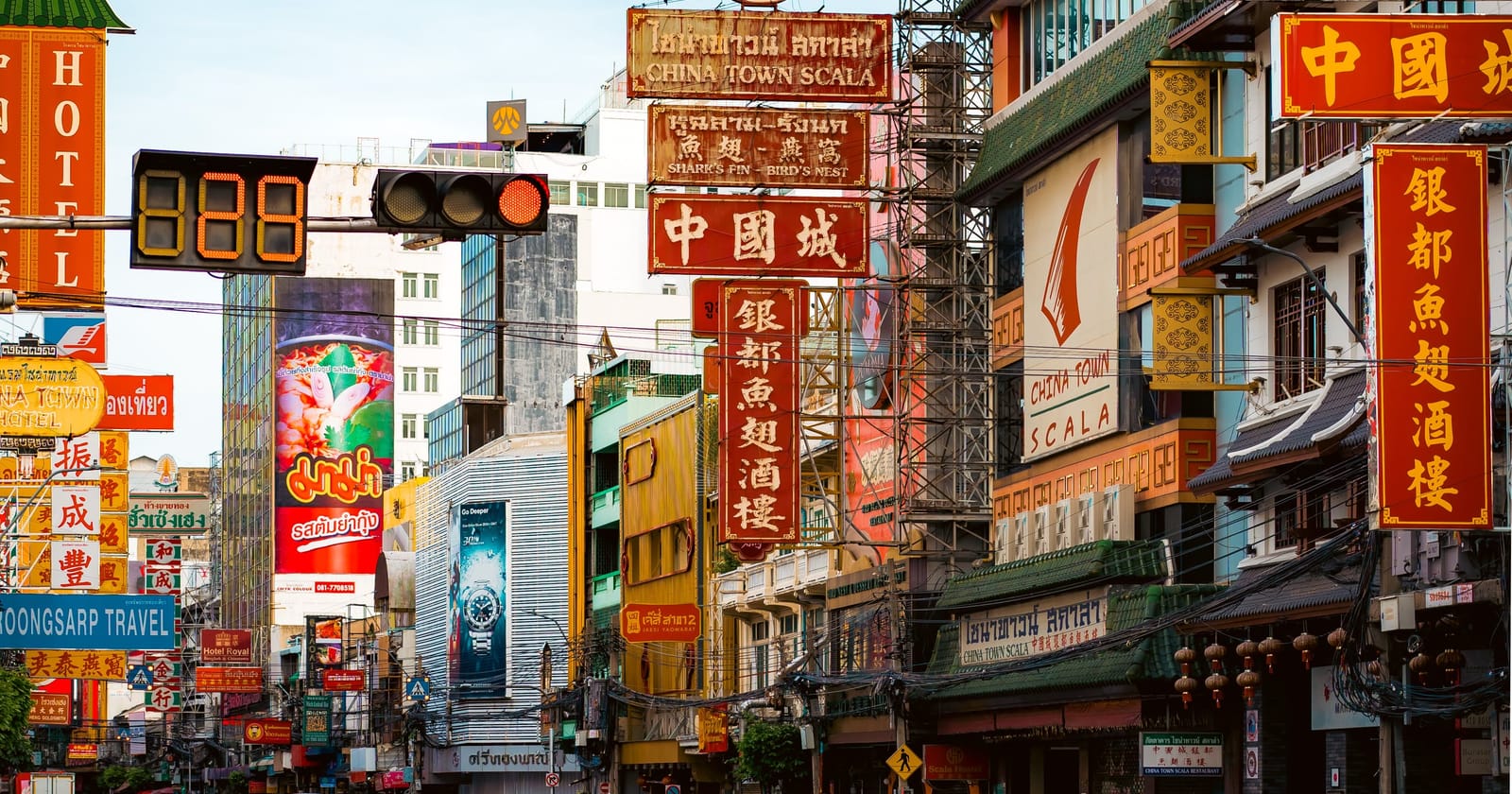 Neon shop signs above Yaowarat Road in Bangkok's Chinatown